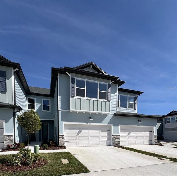 Front exterior of a new home in The Towns At Long Bayou, Seminole, FL, highlighting curb appeal (Image 9).