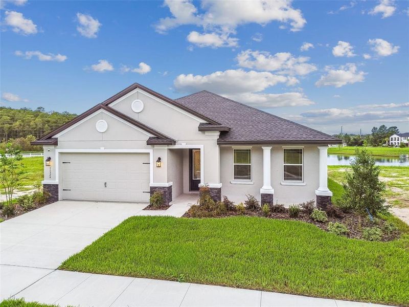 Front exterior of a new home in Hidden Ridge, New Port Richey, FL, highlighting curb appeal (Image 34). Front exterior of a new home in Hidden Ridge, New Port Richey, FL, highlighting curb appeal (Image 34).