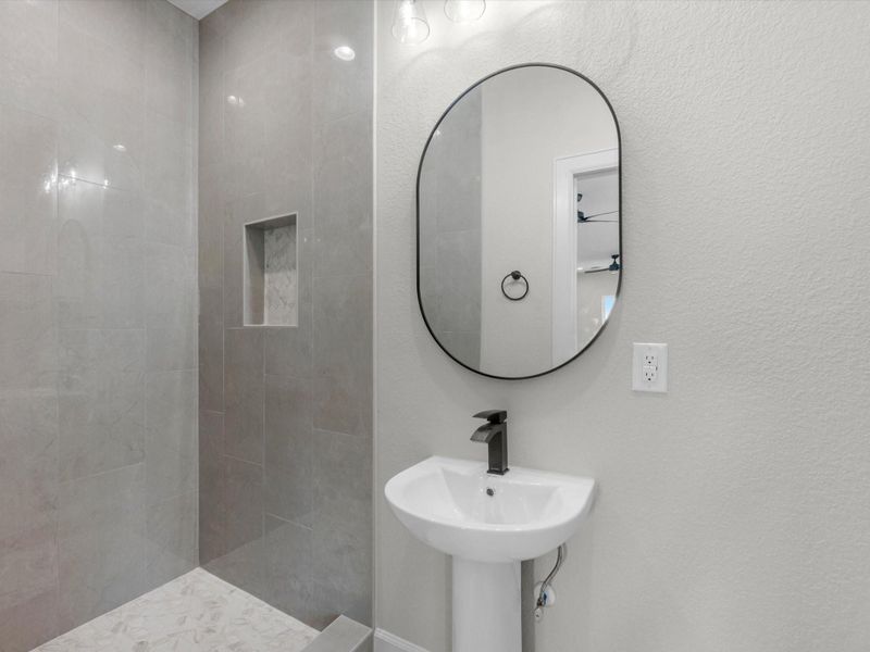 Stylish full bath with walk-in shower, modern fixtures, and sleek finishes.