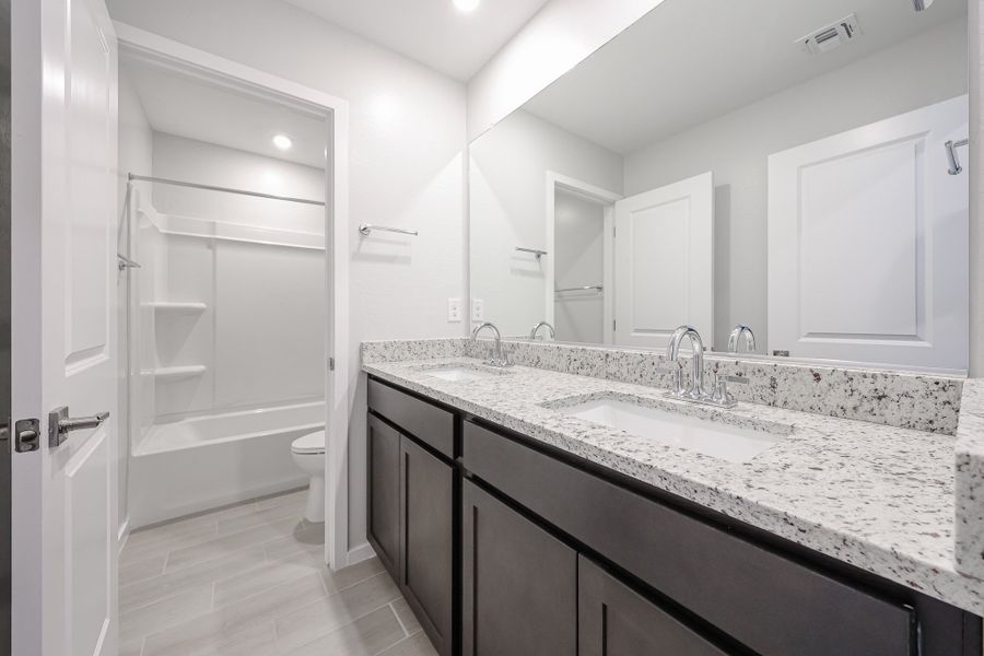 A bathroom with a marble countertop.