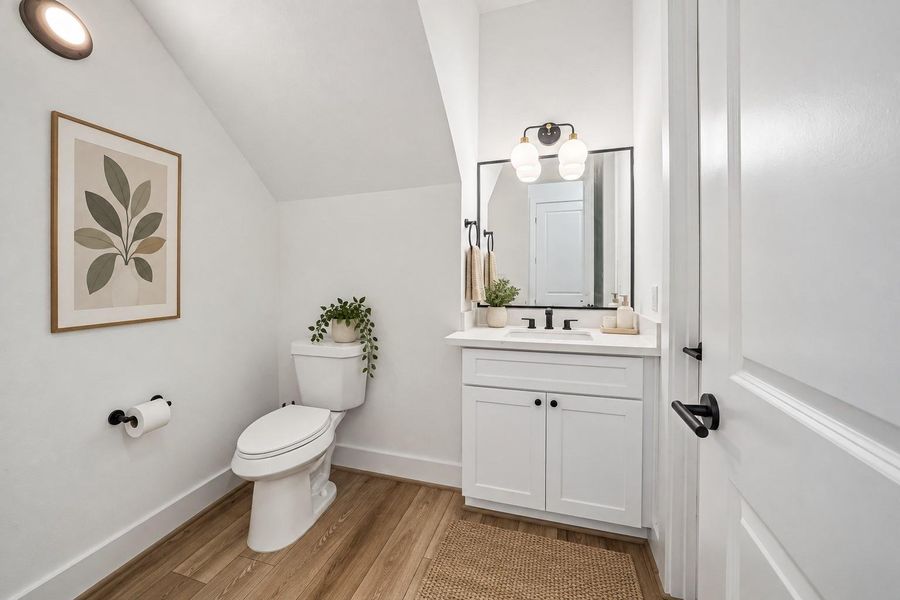 Convenient half bath on 1st floor. Virtual staged.