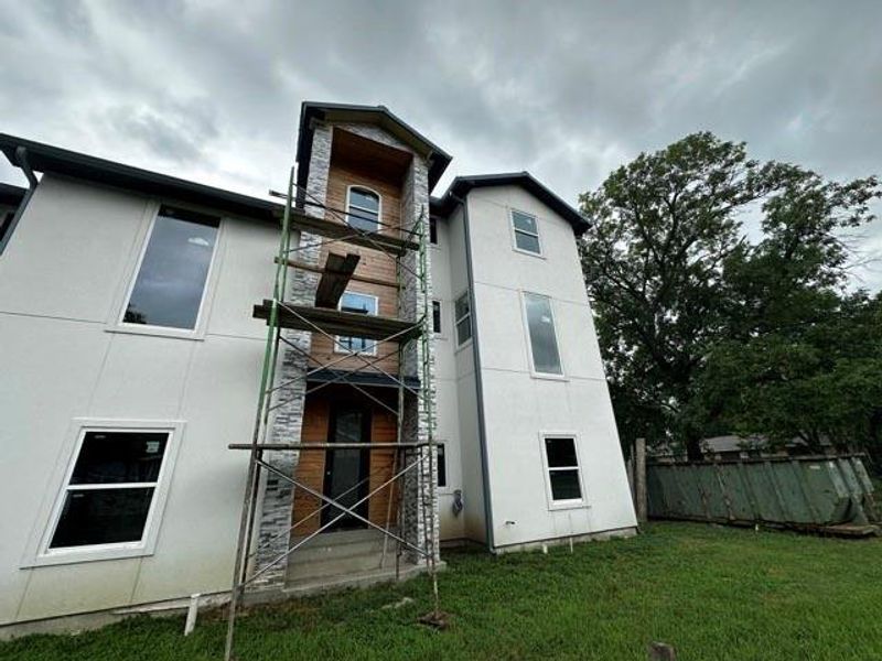 Back of property featuring stucco siding