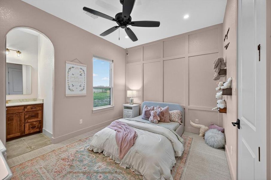 Bedroom featuring wainscoting accent wall, recessed lighting, and a black ceiling fan