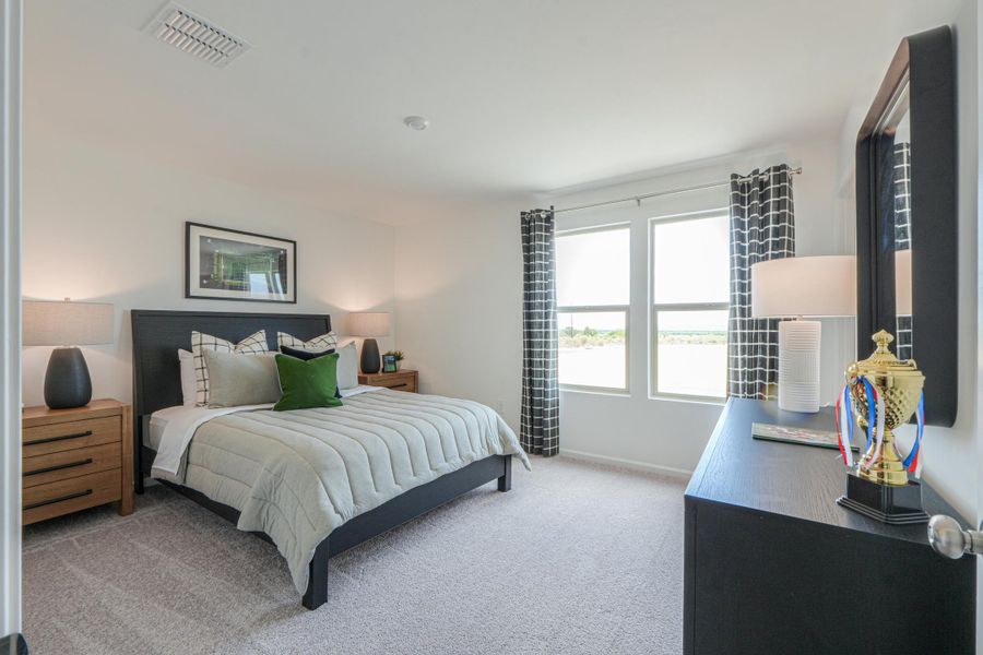 A bedroom with a bed and a tv.