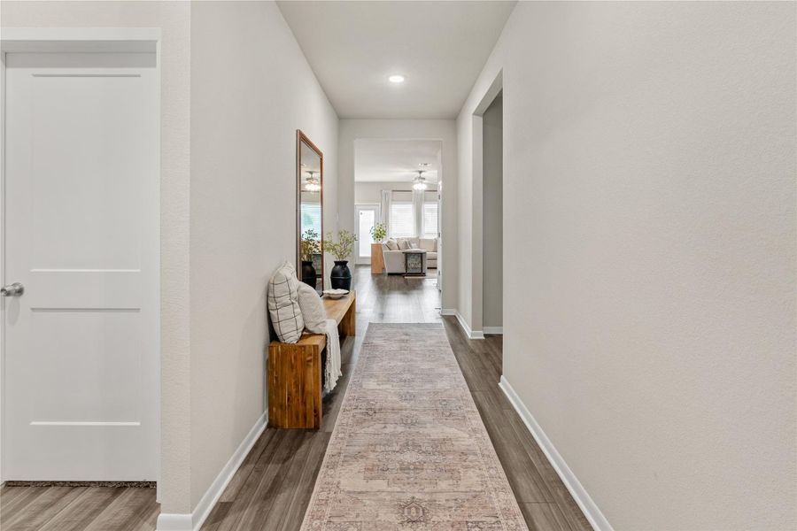 A welcoming entry hall with rich wood flooring leads to an open-concept living area. A welcoming entry hall with rich wood flooring leads to an open-concept living area.