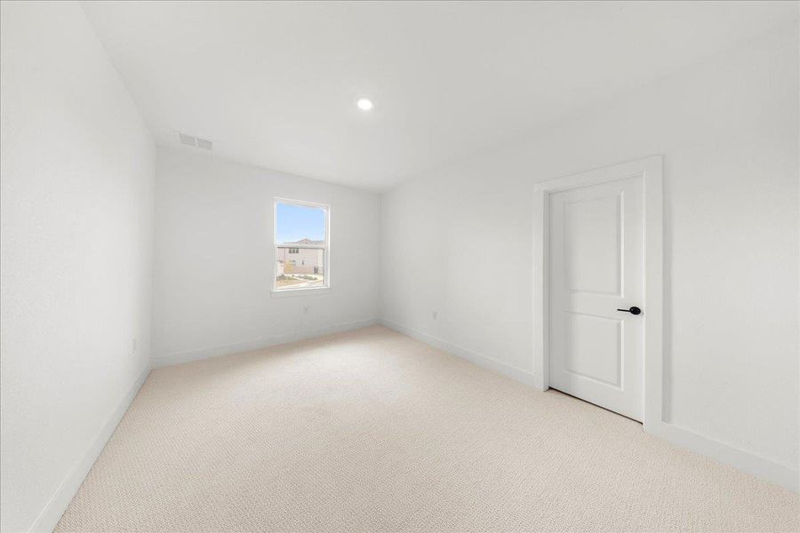 Empty room with light colored carpet and recessed lighting Empty room with light colored carpet and recessed lighting