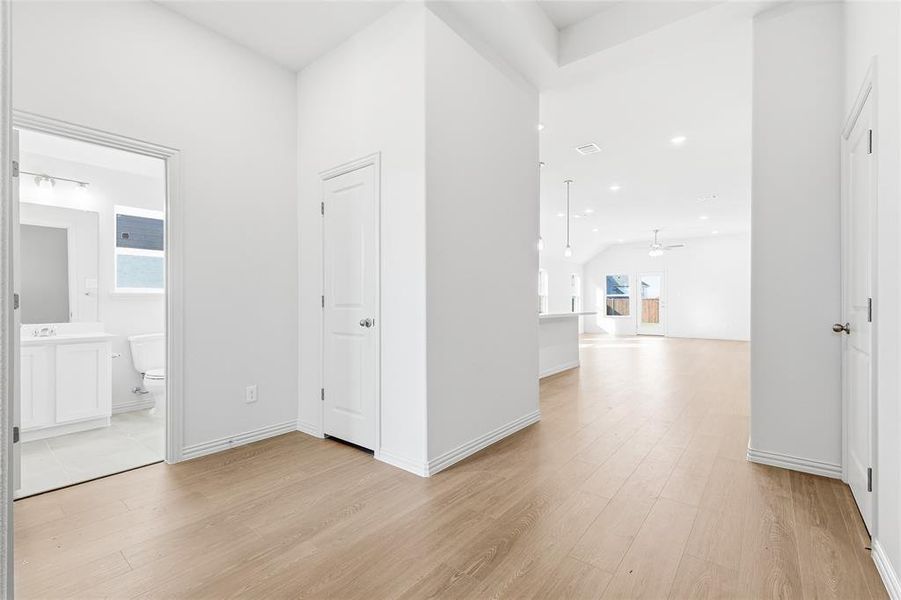 Hall with light wood-style flooring and recessed lighting Hall with light wood-style flooring and recessed lighting