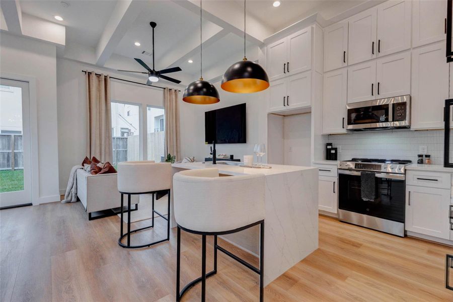 Elegant floor-to-ceiling custom cabinetry and GE Profile appliances enhance this kitchen's modern appeal.