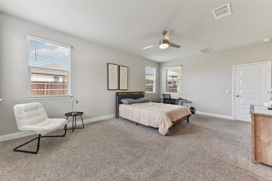 Bedroom featuring carpet floors and a ceiling fan Bedroom featuring carpet floors and a ceiling fan
