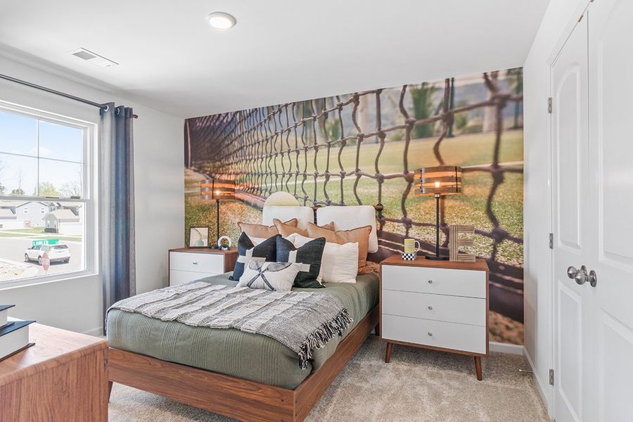 A bedroom with a bed and a window.