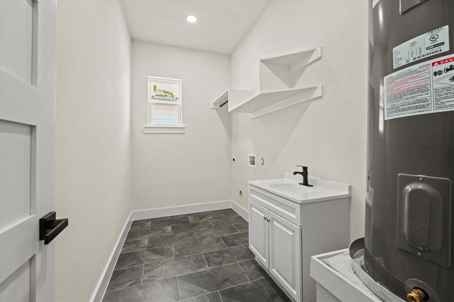 Laundry room featuring electric water heater, electric dryer hookup, washer hookup, and recessed lighting Laundry room featuring electric water heater, electric dryer hookup, washer hookup, and recessed lighting