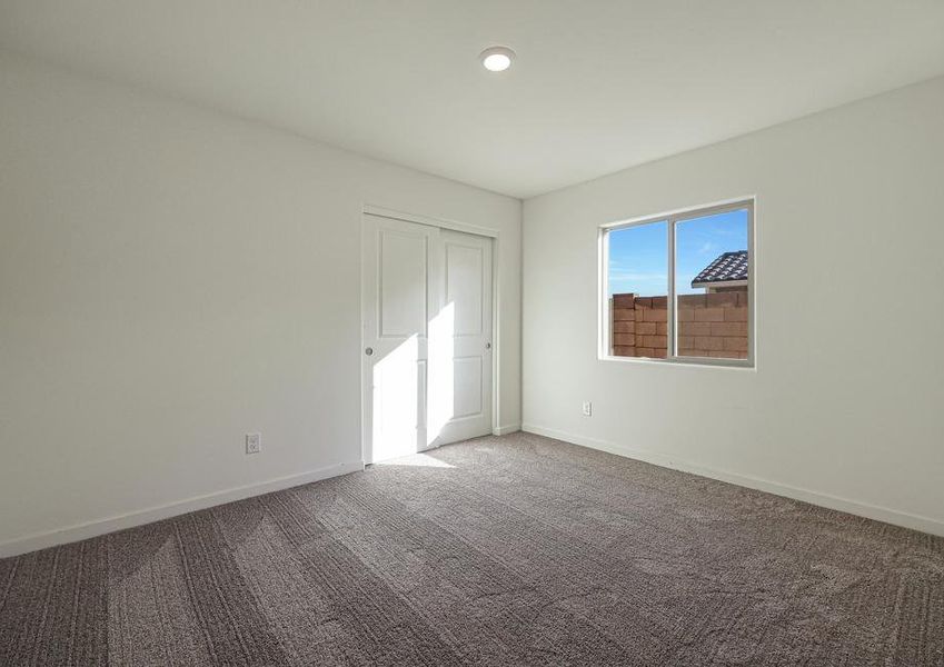 Windows let in plenty of light to this secondary bedroom.