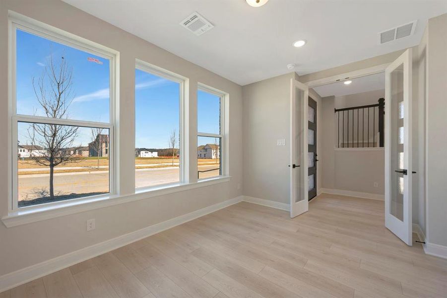 Spare room featuring light wood finished floors and recessed lighting