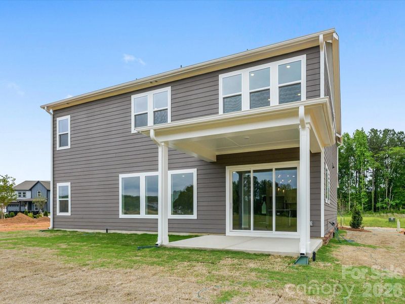 Covered rear porch with telescoping doors.