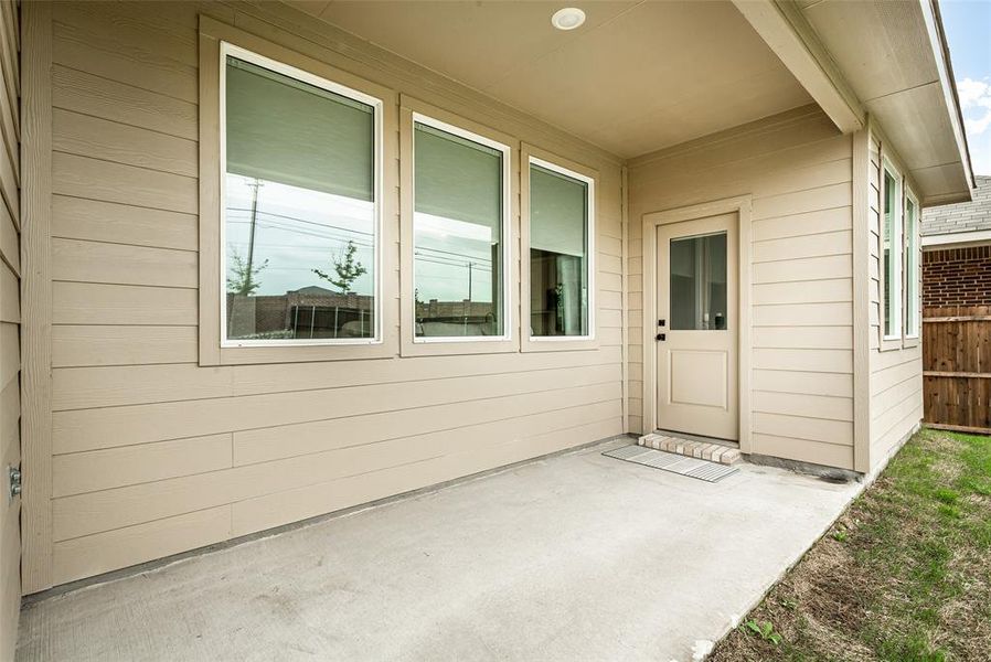 Outdoor patio with a concrete surface, providing a covered area for relaxation