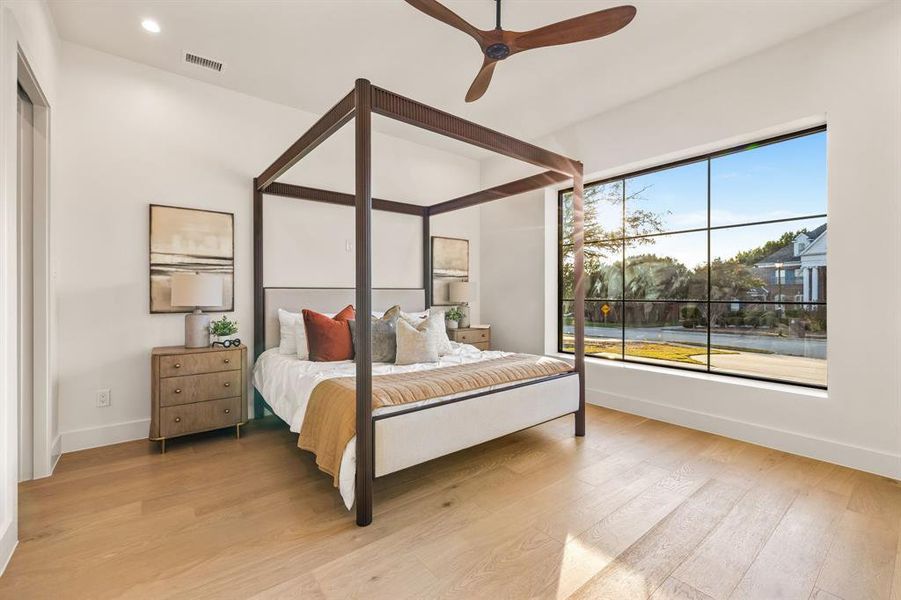 Bedroom with light wood-style flooring, ceiling fan, and recessed lighting Bedroom with light wood-style flooring, ceiling fan, and recessed lighting