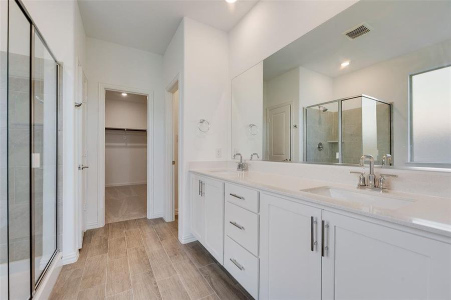 Bathroom with vanity and a shower with shower door