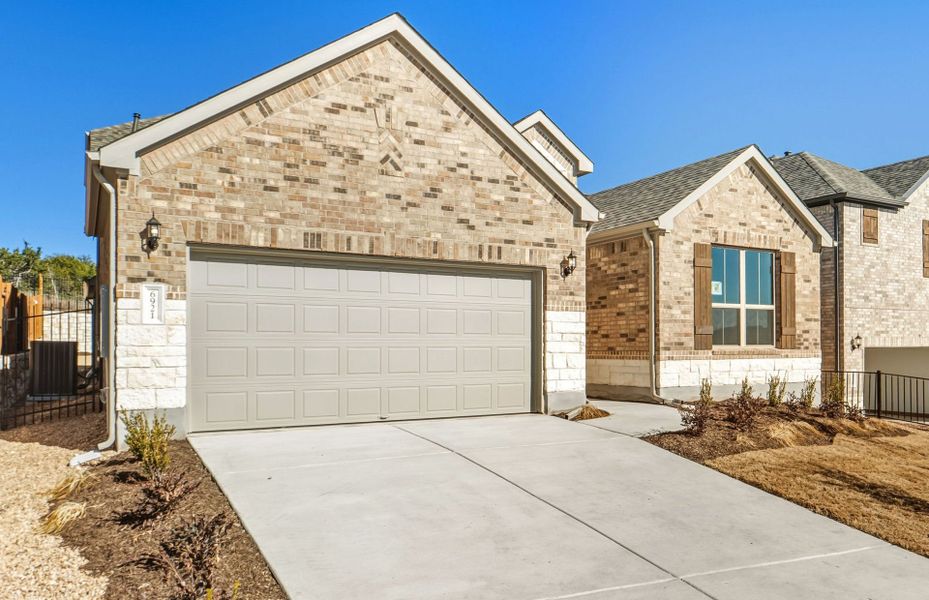 Front exterior of a new home in West Cypress Hills, Spicewood, TX, highlighting curb appeal (Image 2).