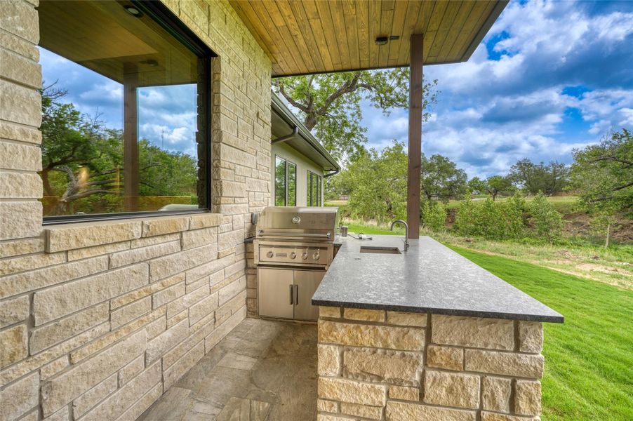 View of patio / terrace featuring area for grilling, a grill, and a sink