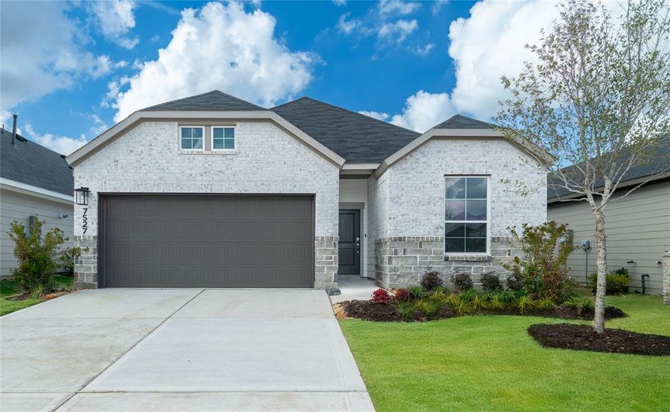 Stunning brick and stone house with beautiful landscaping and curb appeal (Grass virtually enhanced)