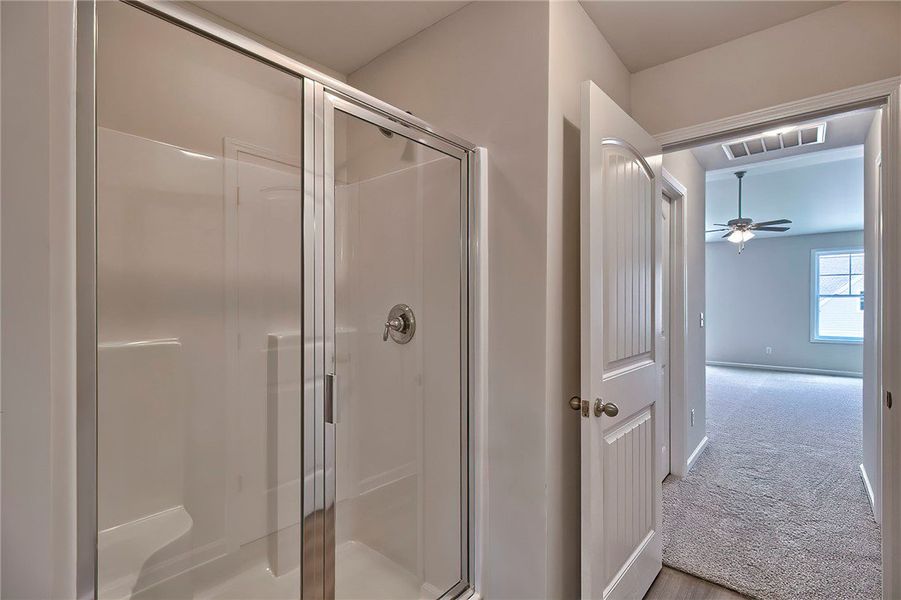 This clean bathroom features a shower with a glass