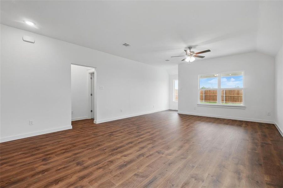 Spare room featuring dark wood finished floors and ceiling fan Spare room featuring dark wood finished floors and ceiling fan