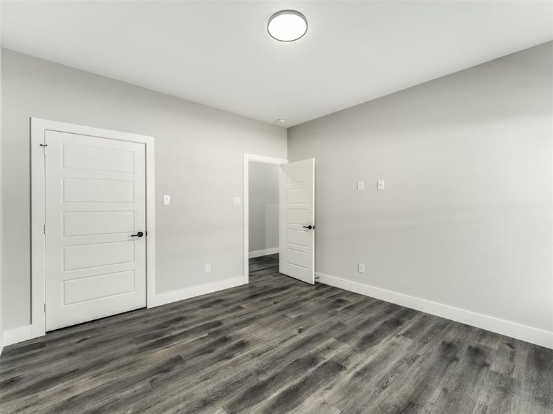 Empty room featuring dark wood-type flooring