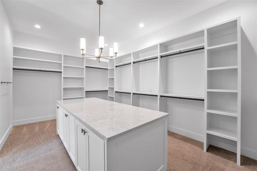 Texas size primary closet with large island.