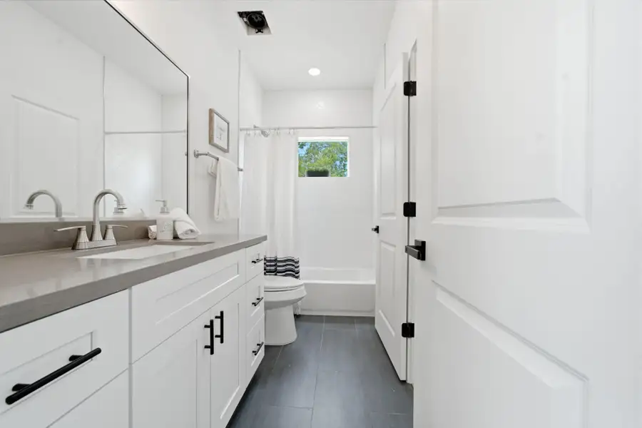 This spacious Jack-and-Jill bathroom joins the two secondary bedrooms.