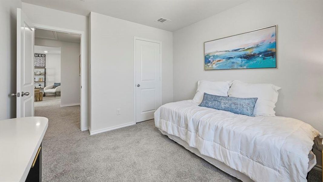 Bedroom featuring light carpet and baseboards Bedroom featuring light carpet and baseboards