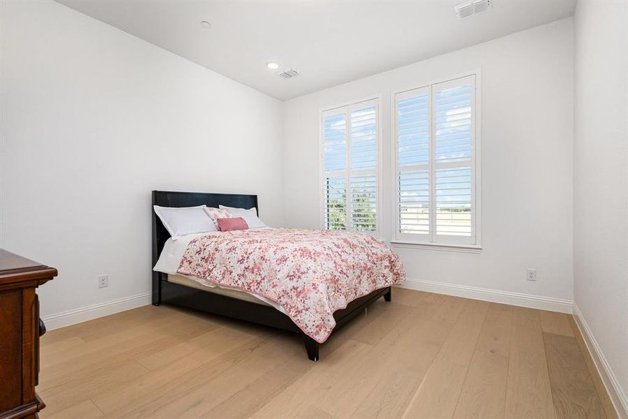 Bedroom featuring light wood-type flooring and baseboards