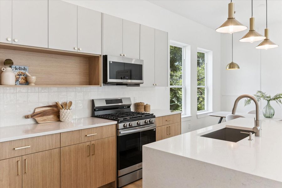 The kitchen is a dream with a deep stainless farm sink and gas range, as well as thoughtful shelving for every day dining pieces, cook books or decorative items. The kitchen is a dream with a deep stainless farm sink and gas range, as well as thoughtful shelving for every day dining pieces, cook books or decorative items.