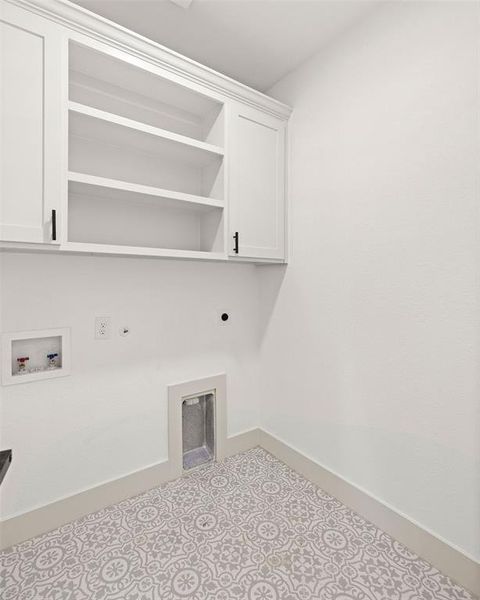 Clothes washing area with cabinet space, baseboards, washer hookup, and electric dryer hookup