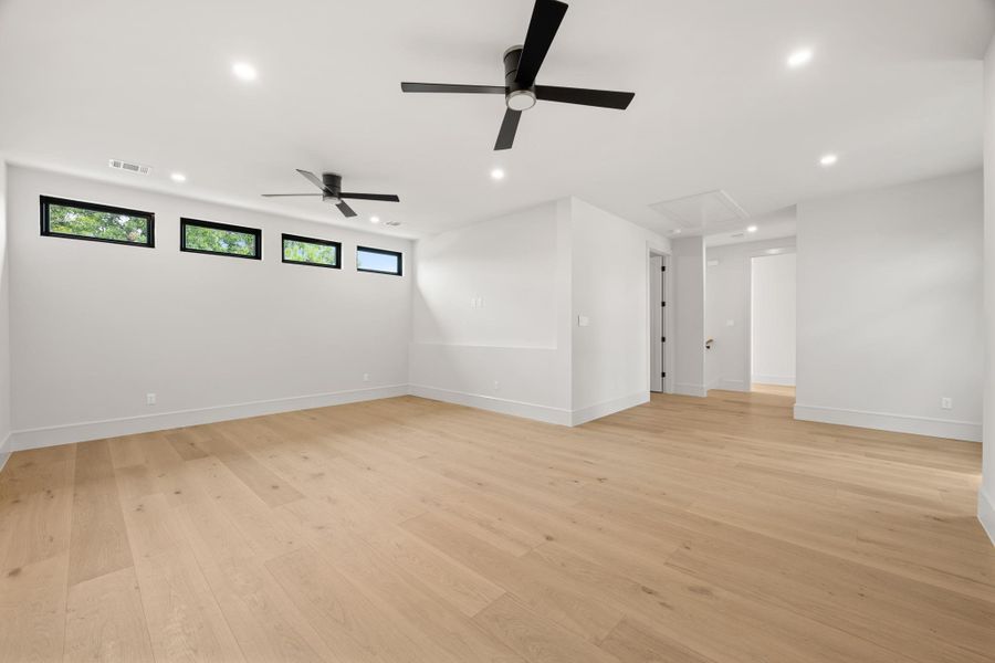 Crisp white walls pair with light wood flooring in this open living area.