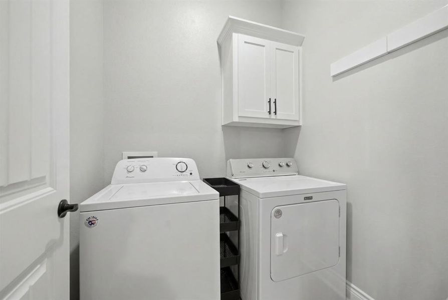 Laundry area with washing machine and dryer and cabinet space