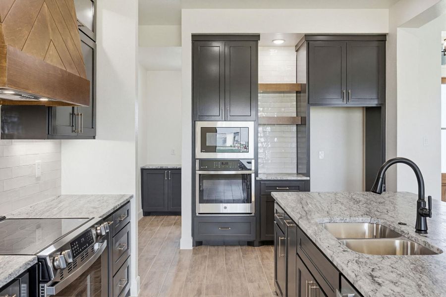 Culinary aspirations come alive in this meticulously appointed kitchen featuring an expansive island and sleek cabinetry. Culinary aspirations come alive in this meticulously appointed kitchen featuring an expansive island and sleek cabinetry.
