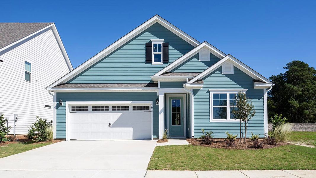 Front exterior of a new home in Indigo Preserve, Leland, NC, highlighting curb appeal (Image 1). Front exterior of a new home in Indigo Preserve, Leland, NC, highlighting curb appeal (Image 1).