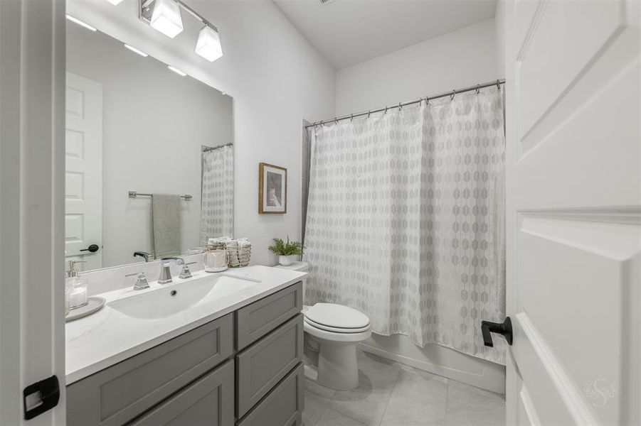 The guest room suite includes an en suite bathroom that is absolutely pristine.  Note the neutral color palette that continues through the home.