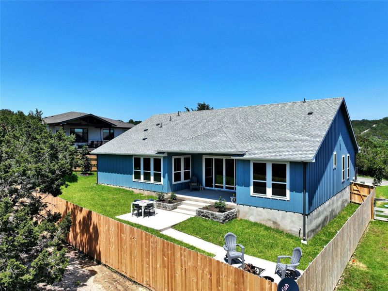 Blue siding exterior with a light gray shingle roof
