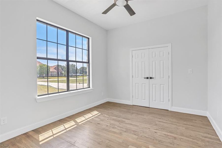 Unfurnished room featuring ceiling fan and light wood-type flooring