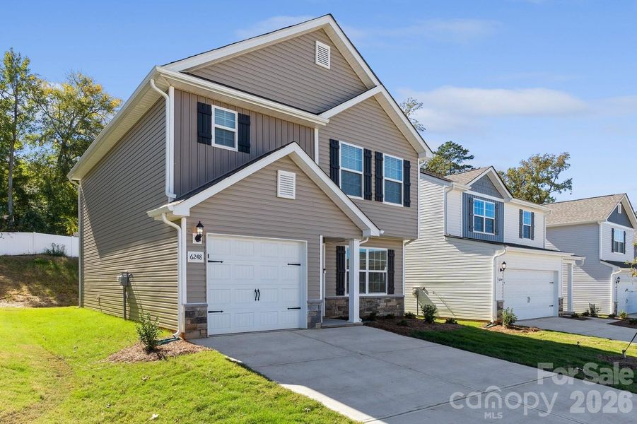 Front exterior of a new home in Creedmore Hills, Charlotte, NC, highlighting curb appeal (Image 1). Front exterior of a new home in Creedmore Hills, Charlotte, NC, highlighting curb appeal (Image 1).