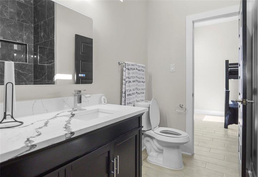 Full bathroom with vanity and wood tiled floors