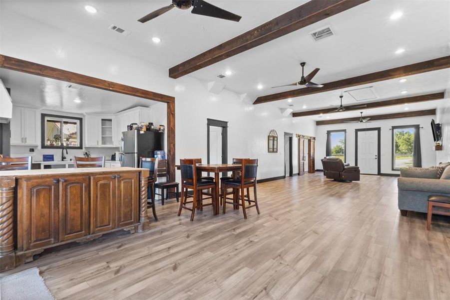 Dining room featuring recessed lighting, light wood-style floors, a ceiling fan, and beamed ceiling Dining room featuring recessed lighting, light wood-style floors, a ceiling fan, and beamed ceiling