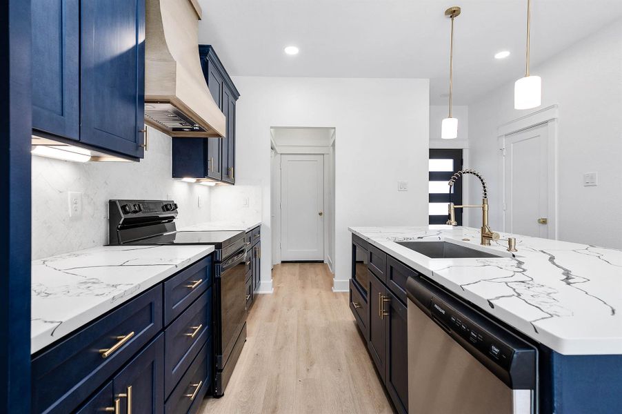 Welcoming entry view opening into a bright, open-concept living and kitchen area with modern finishes.
