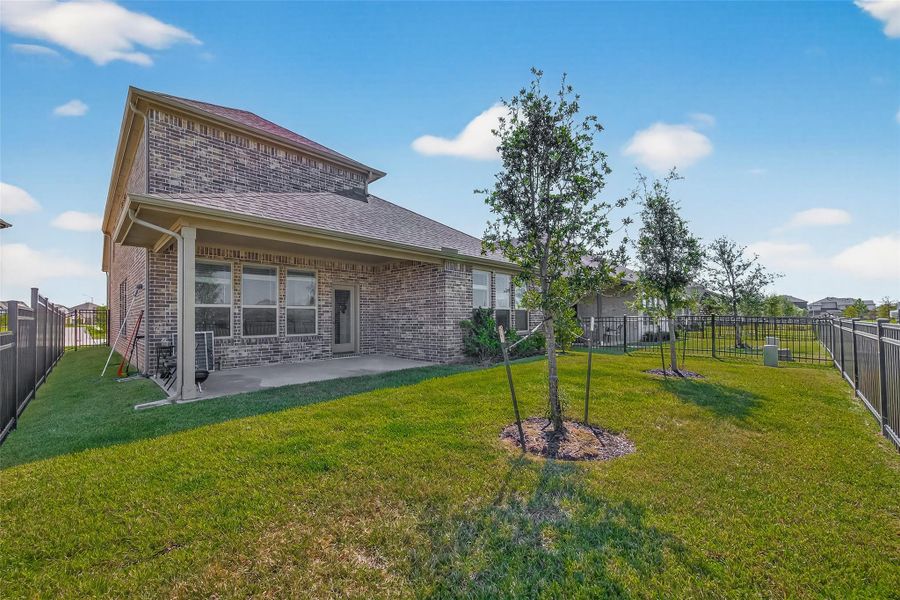 Exterior details and patio area of a home in Sunterra, Katy (Image 30).