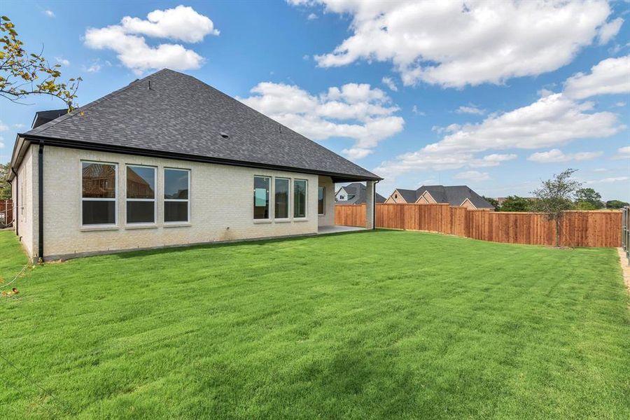 Rear view of property featuring a yard