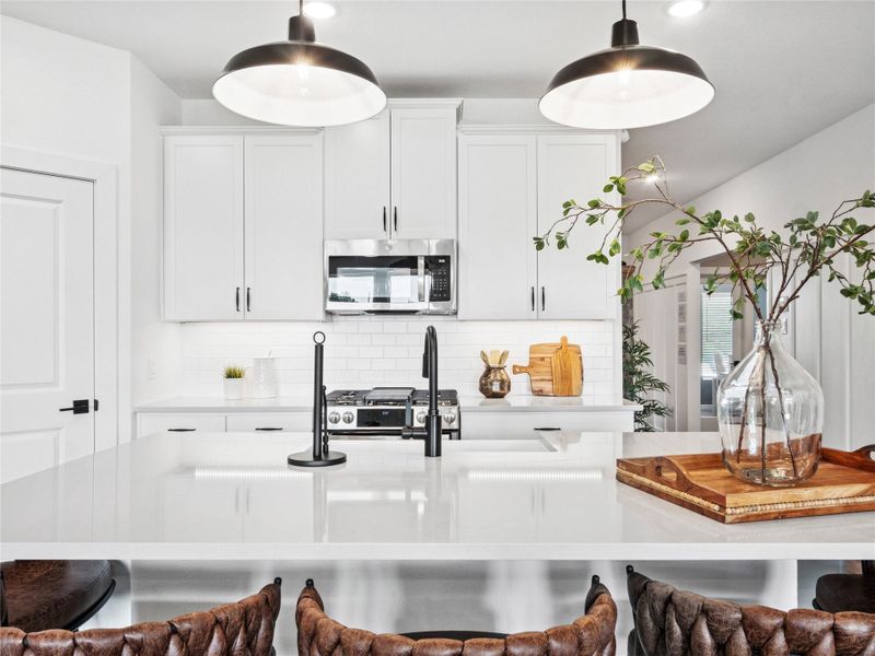 Chef worthy kitchen with white cabinets and quartz countertops