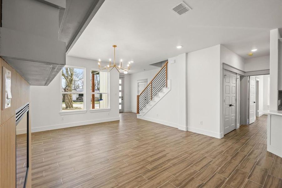 Unfurnished living room with a chandelier