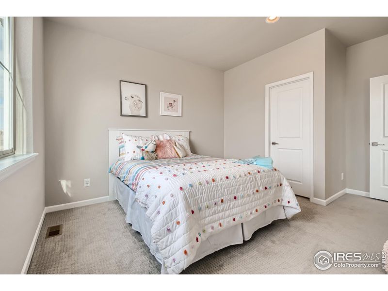Second bedroom *Photo not of actual home, but same floorplan and style/colors*