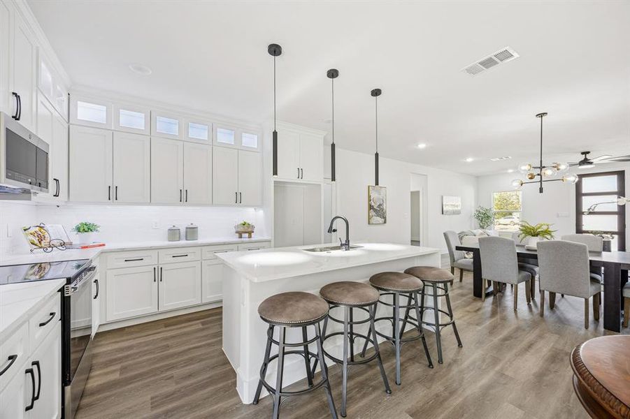 Kitchen with stainless steel appliances including an electric range.